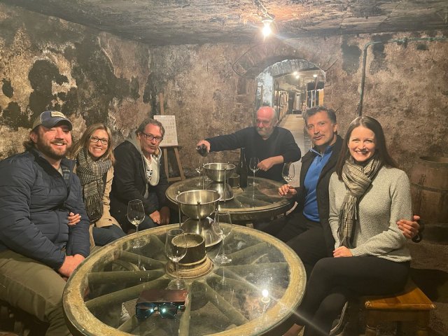 Travelers Elizabeth & Majid Afshar and Moira & Ron Workman at a wine tasting in a Burgundy wine cellar