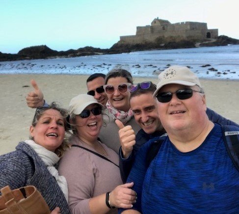 Travelers Ann & Jim Hichak with the locals on the beach at Saint-Malo