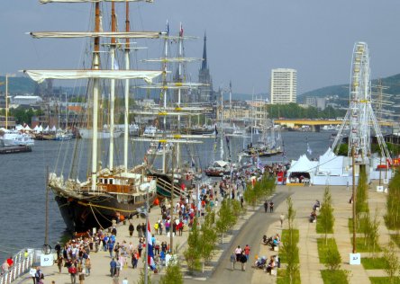 Tall ships along the Seine River in Normandy and people on the quays during the Rouen Armada