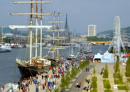 Tall ships along the Seine River in Normandy and people on the quays during the Rouen Armada