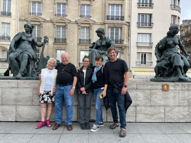 Travelers standing and smiling outside the Musee D'Orsay in Paris