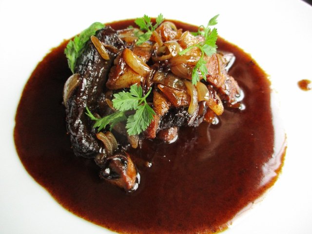 Savor Coq au vin with a glass of Burgundy Coq au vin - chicken in wine sauce