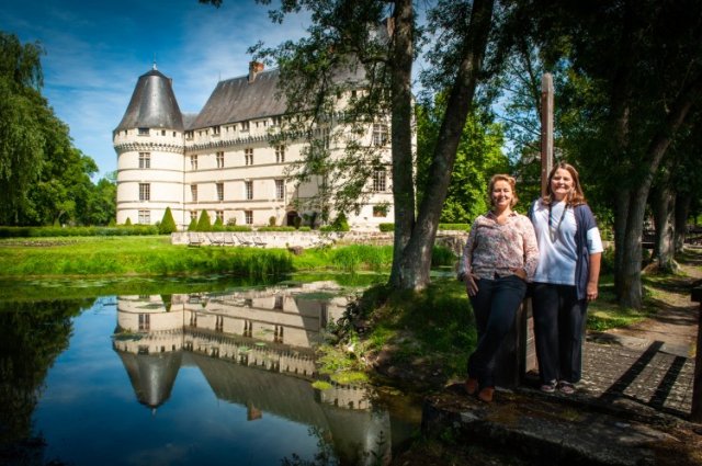 Trip Planners Emilie & Laura at Chateau de l'Islette Trip planners Emilie & Laura standing in front of the lake and Chateau de l'Islette in the Loire Valley