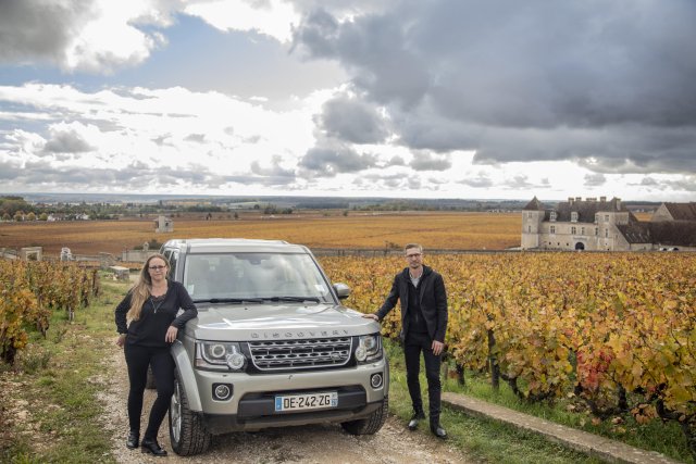 Wine experts Eve and Sebastien with their jeep in the Burgundy vineyards