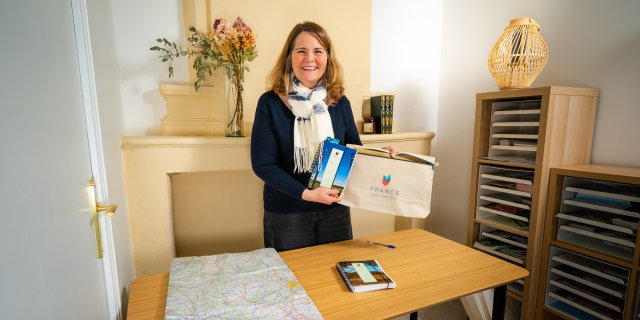 Senior Trip Planner Laura adding the guidebook to a travel pack