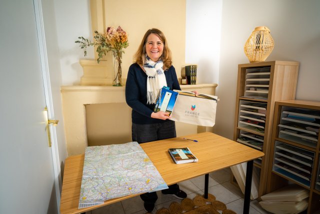 Senior Trip Planner Laura preparing a France Just For You travel pack