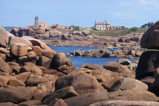 Lighthouse at Ploumanach in Brittany, France with huge pink granite boulders