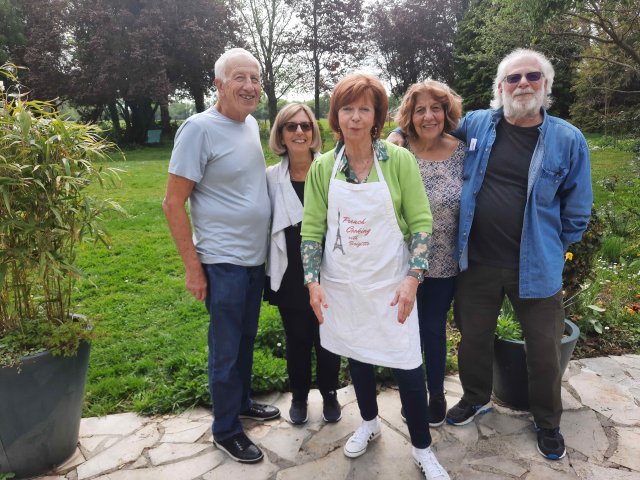 Brigitte and travelers in her garden after a cooking class