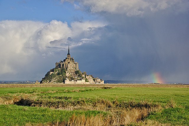 View of Mont Saint-Michel Abbey with a rainbow in the sky