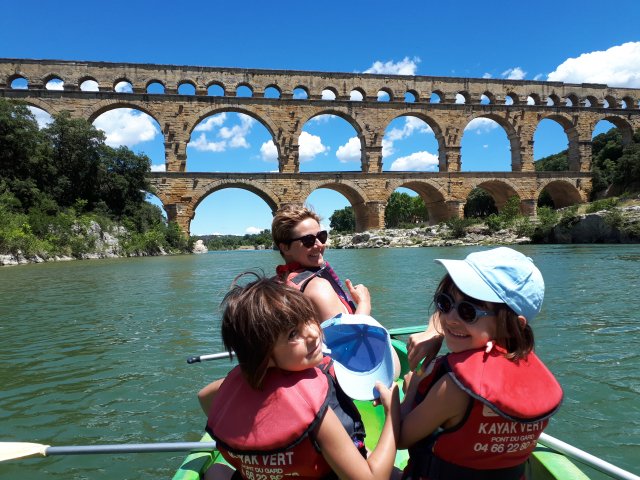 Emilie, and daughters Jeanne and Pauline kayaking in front of the Pont du Gard Roman Aqueduct in Provence