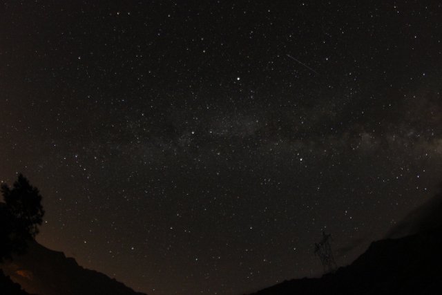 A black sky full of stars and shooting stars in the Pyrenees mountains