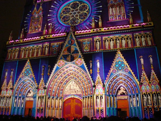 The front of Saint John the Baptist Cathedral in Lyon covered in Christmas lights