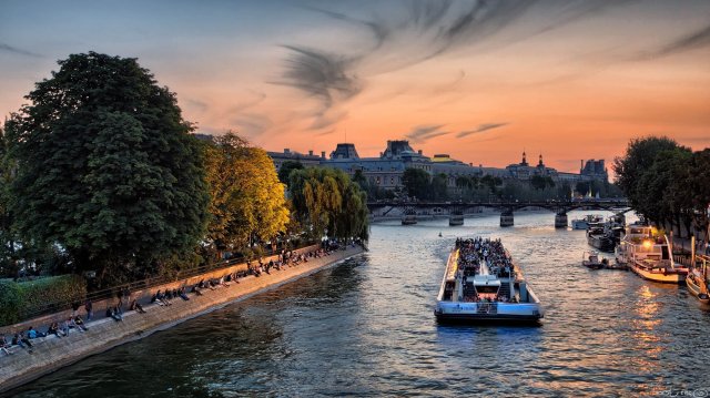 A boat on the Seine river at sunset