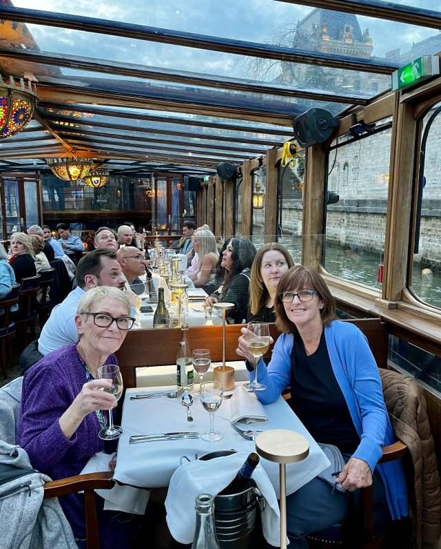 Travelers Therese & Maryanne enjoying a dinner cruise on the Seine in Paris