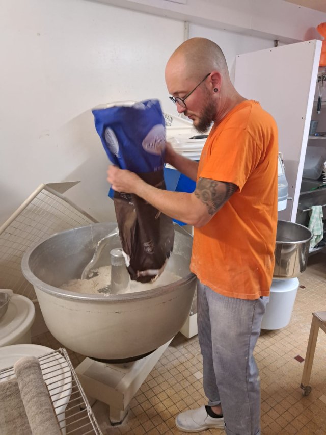 Xavier adding the flour, water, salt and yeast to make the baguette