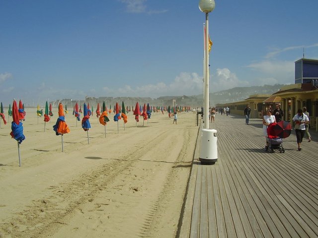 The golden sandy beach of Deauville Normandy with its colorful beach umbrellas