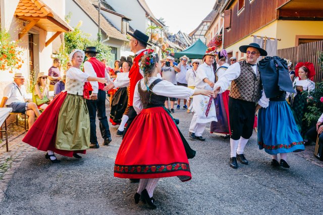 Festivities during the Eguisheim Winegrowers' Festival People in traditional Alsatian costumes dancing during the wine festival