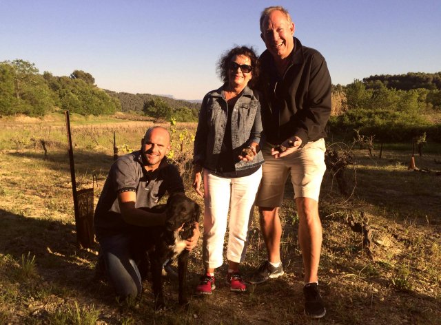 Travelers Kathy & Mark with an expert truffle hunter and his dog in France