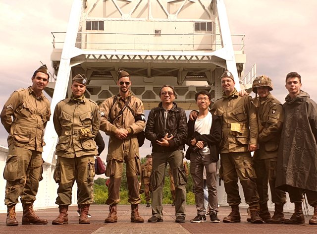 Travelers Chee Keong & Zack on the Pegasus Bridge on the D-Day Anniversary