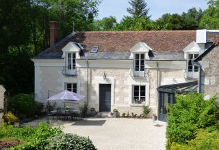 A charming tuffeau stone house in a green valley