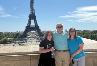 Travelers Bill & Ellen sent us this photo of them in front of the Eiffel Tower in Paris