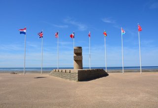 Flags and a war memorial at Juno beach 