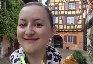 FJFY copywriter Naomi outside Kouglopf & Cie bakery enjoying a warm pain au chocolat