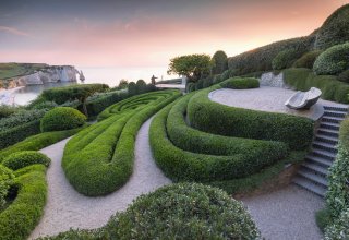 Les Jardins d'Etretat with a view of the white cliffs of Etretat in the background
