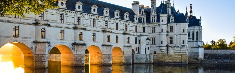 Chenonceau castle with its grand arches over the Loire Valley River