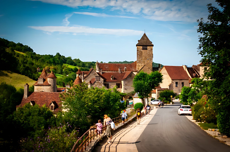 Stone houses surrounded by green countryside in a traditional French village