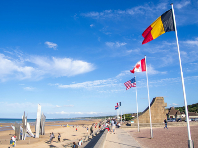 Les Braves memorial at Omaha Beach. You can see the Belgian, Canadian, American and French flags