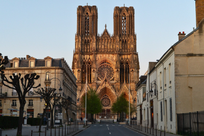 Front view of Reims cathedral bathed in afternoon sunlight