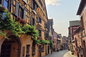 Colorful, half-timbered houses in an empty street in Riquewihr, Alsace