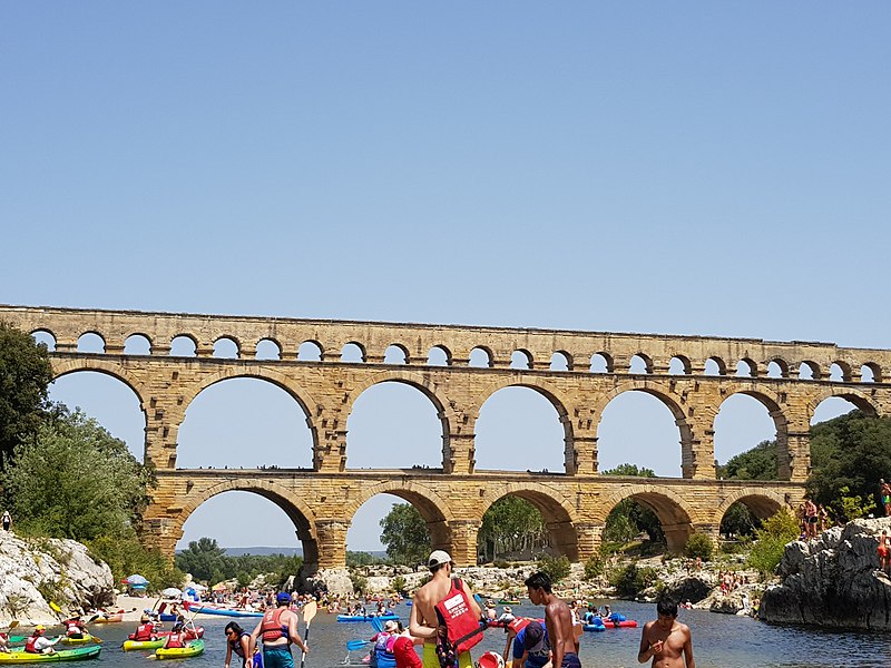 Tourists and canoes at the Pont du gard roman bridge in provence